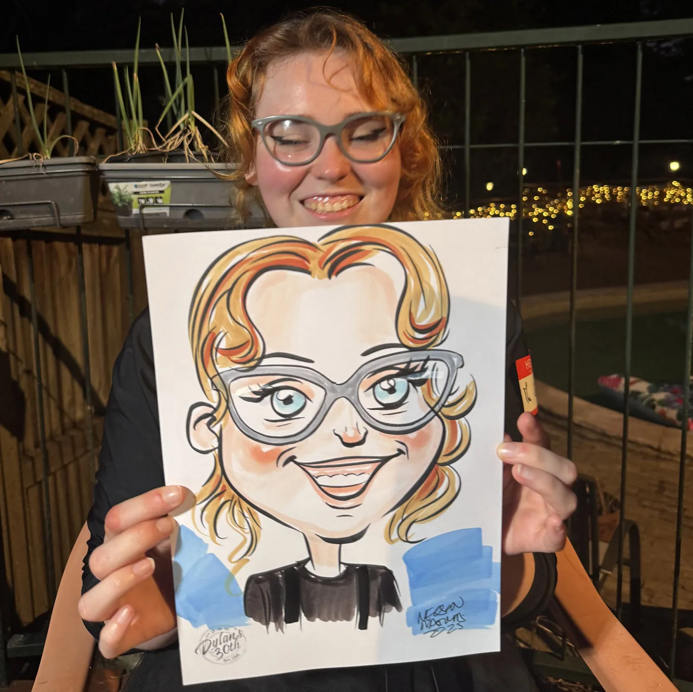 Person holding a hand-drawn caricature