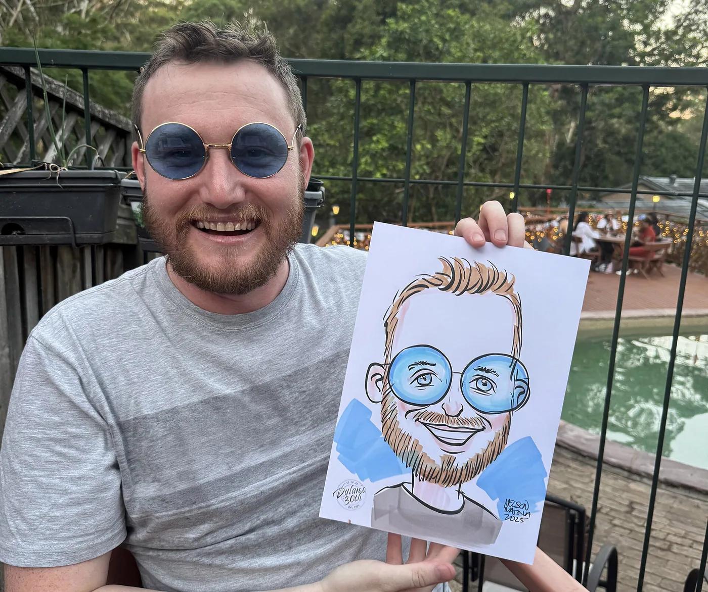 Person holding a hand-drawn caricature