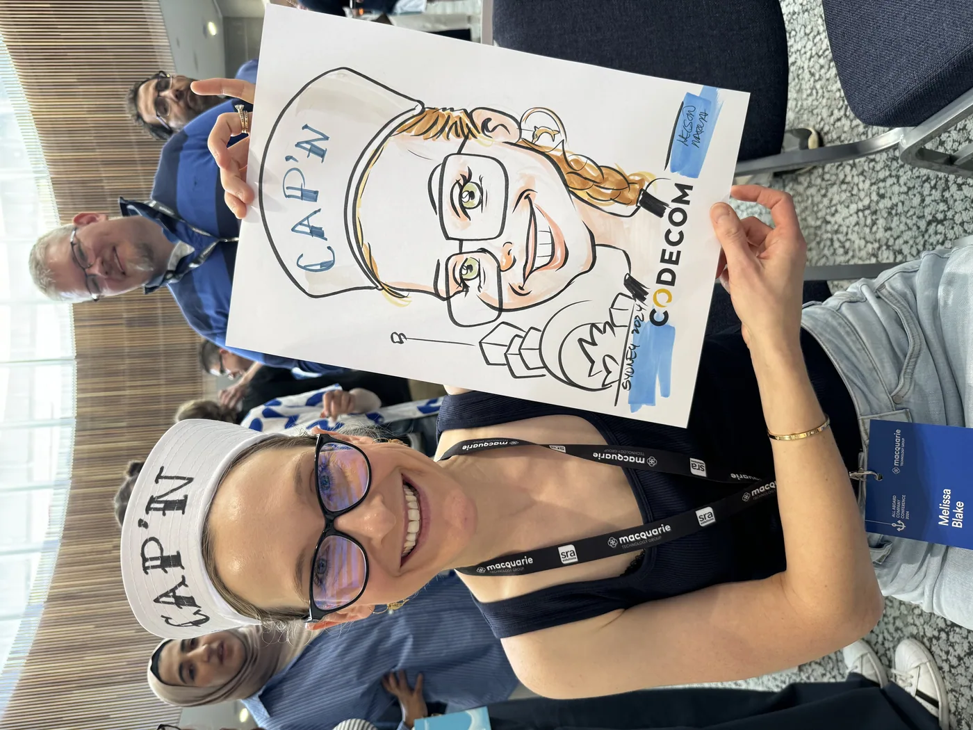 Person holding a hand-drawn caricature