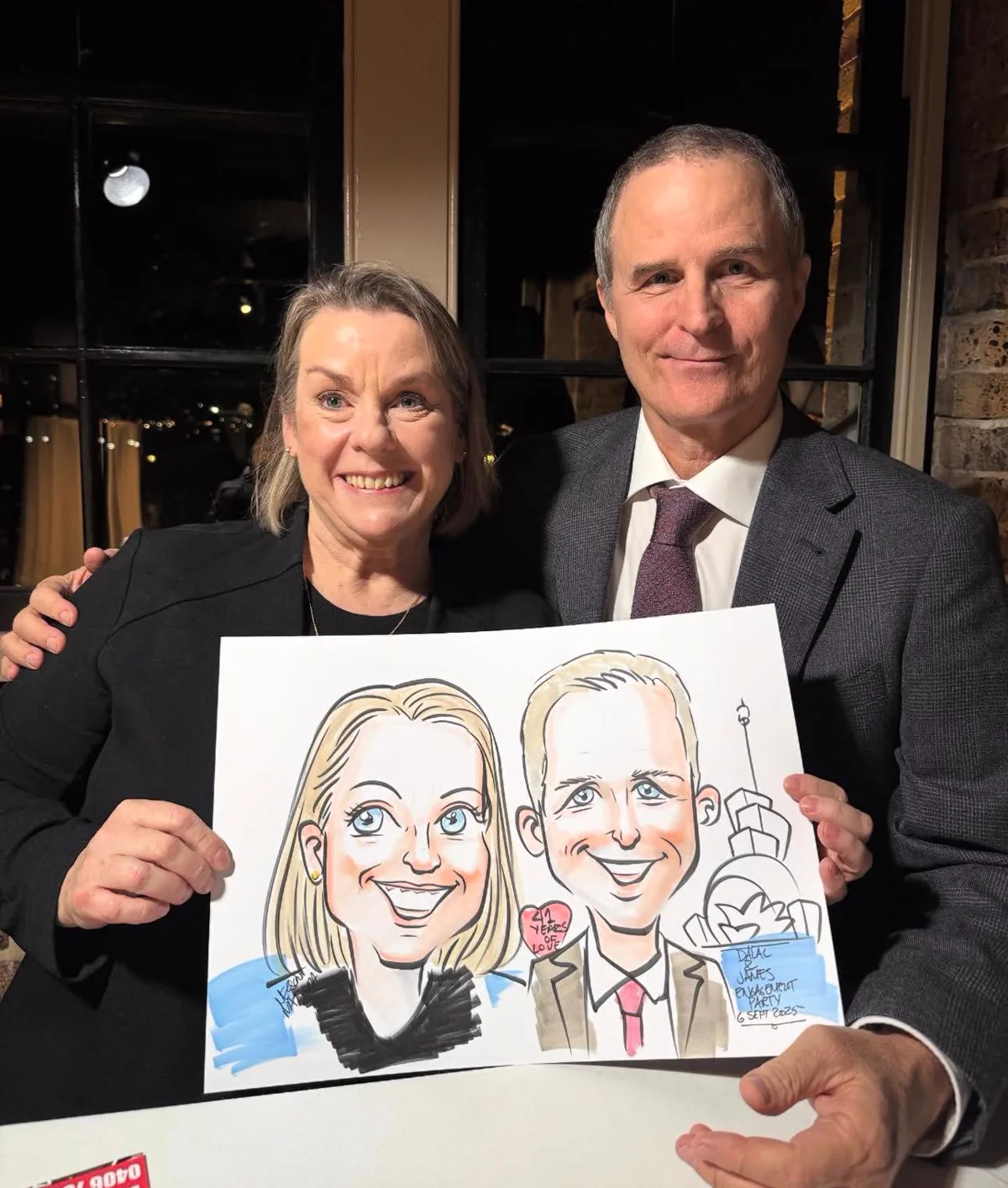 Wedding guests holding a live caricature