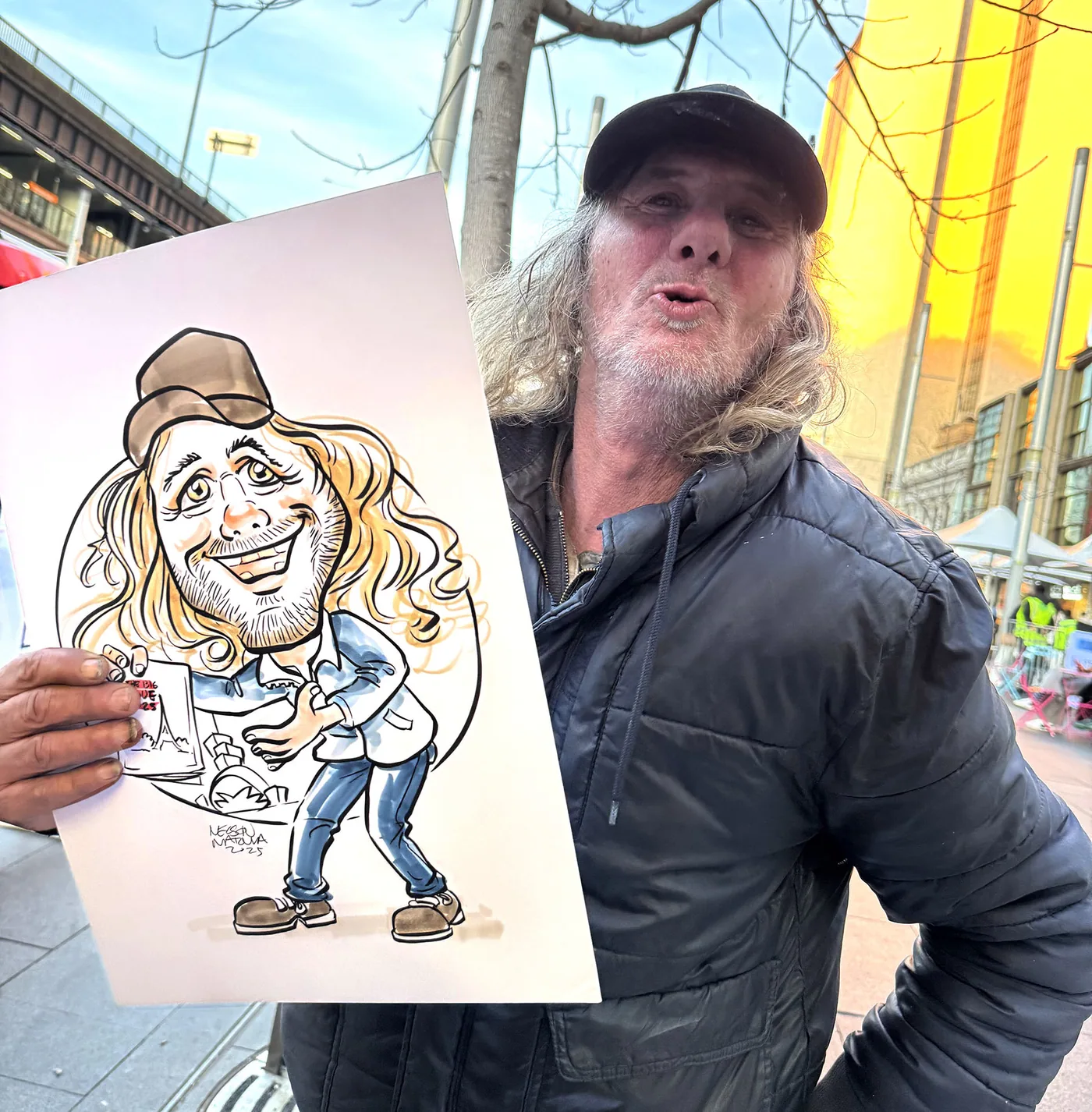 Person holding a hand-drawn caricature