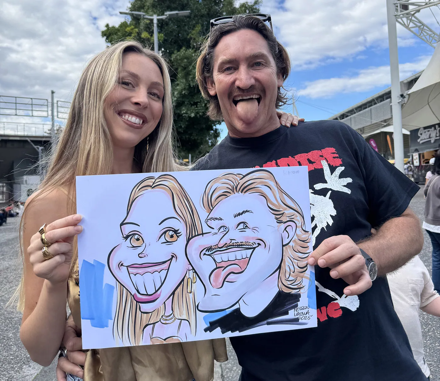 Person holding a hand-drawn caricature