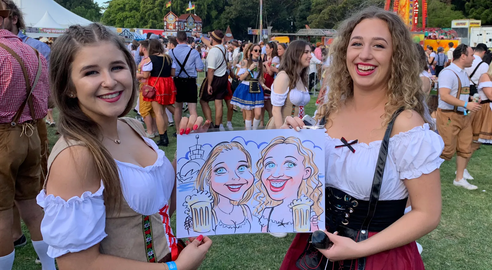 Festival guests holding their caricature