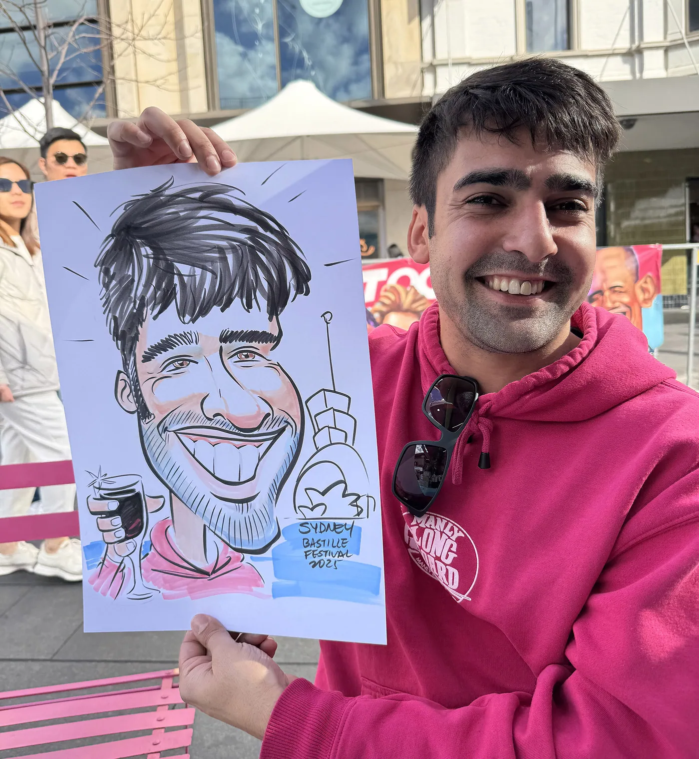 Person holding a hand-drawn caricature