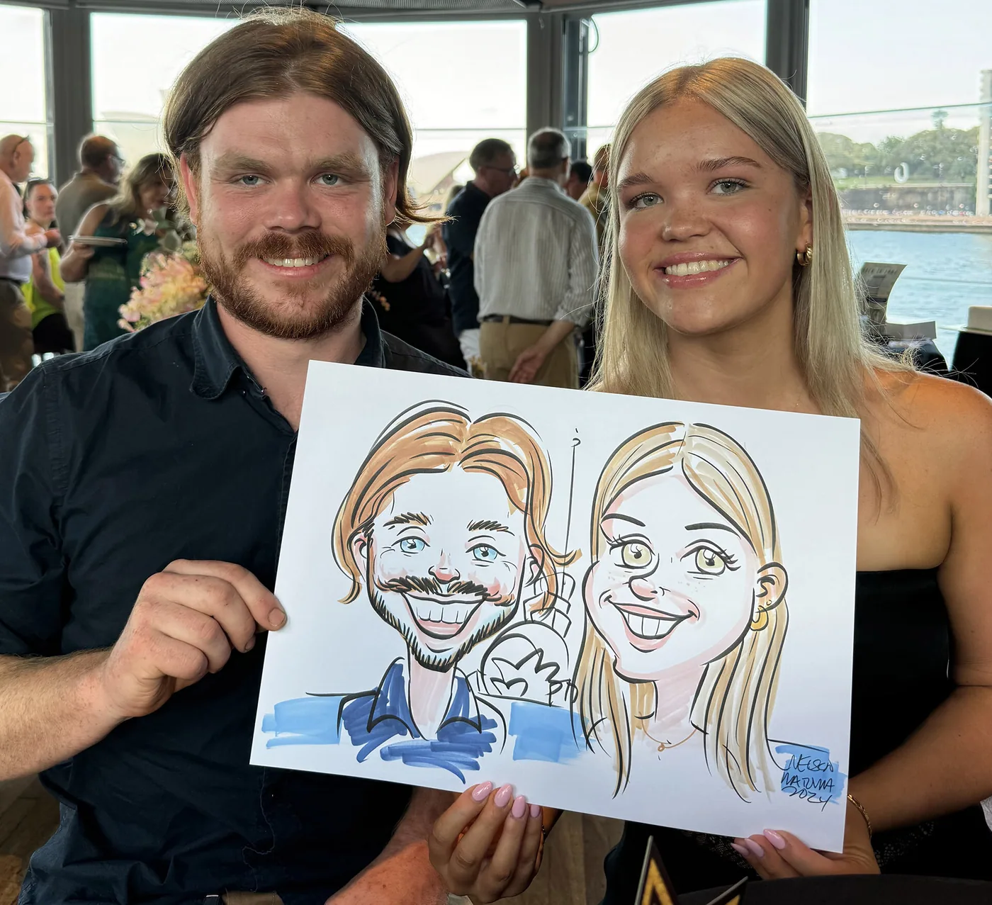 Person holding a hand-drawn caricature
