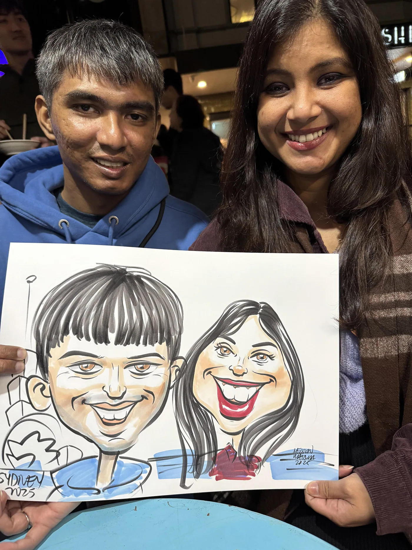 Person holding a hand-drawn caricature