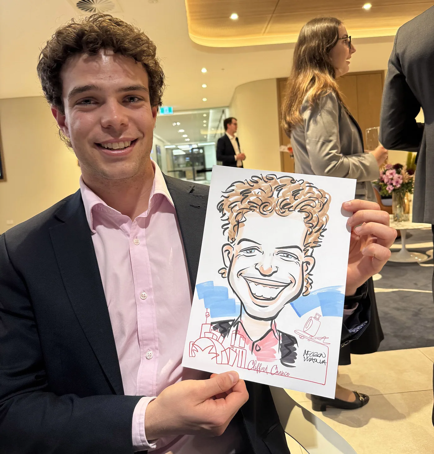 Person holding a hand-drawn caricature
