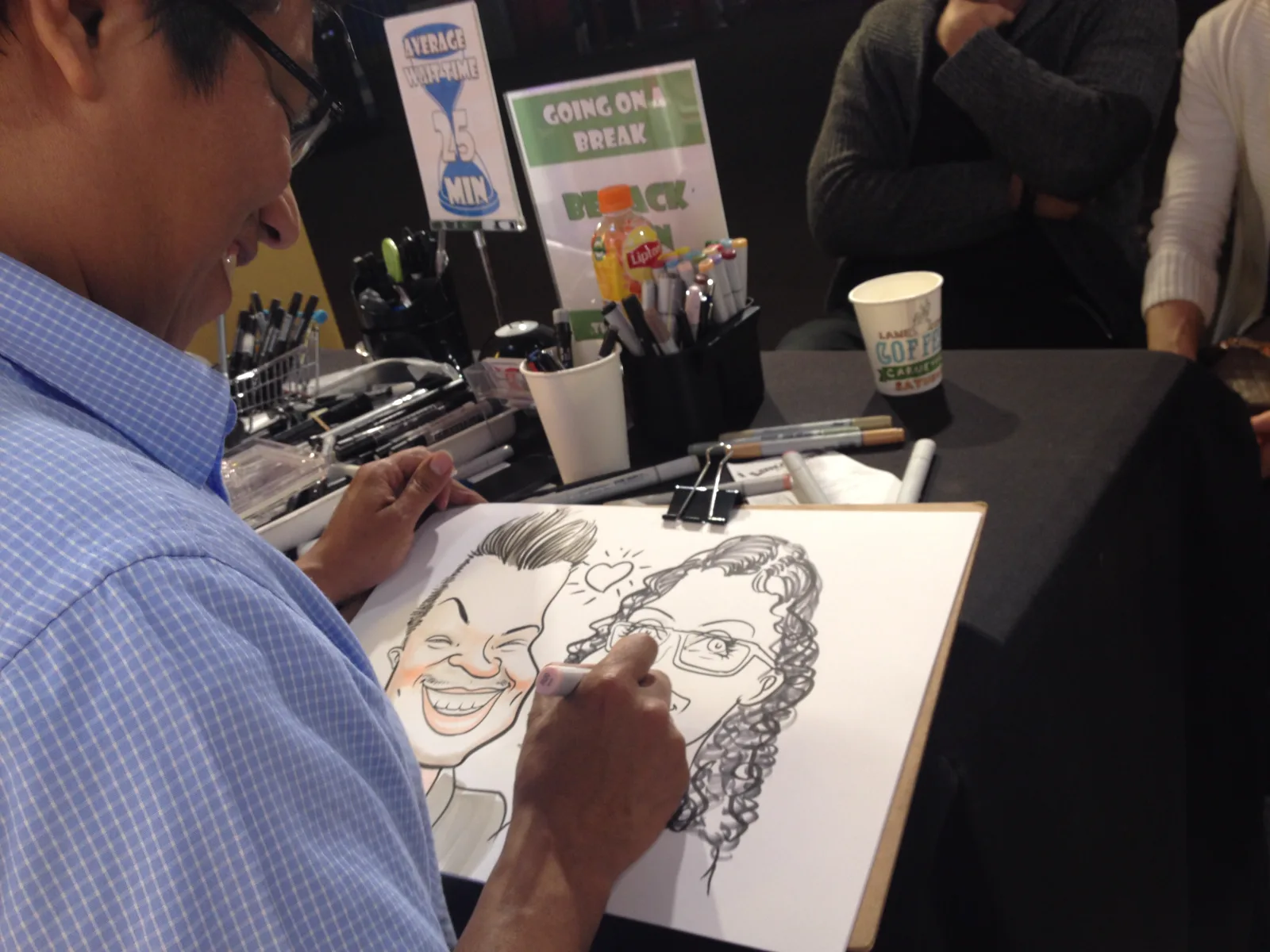 Nelson drawing a caricature at an event